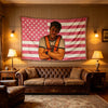 A rustic living room featuring a leather sofa and a large American flag tapestry on the wall.