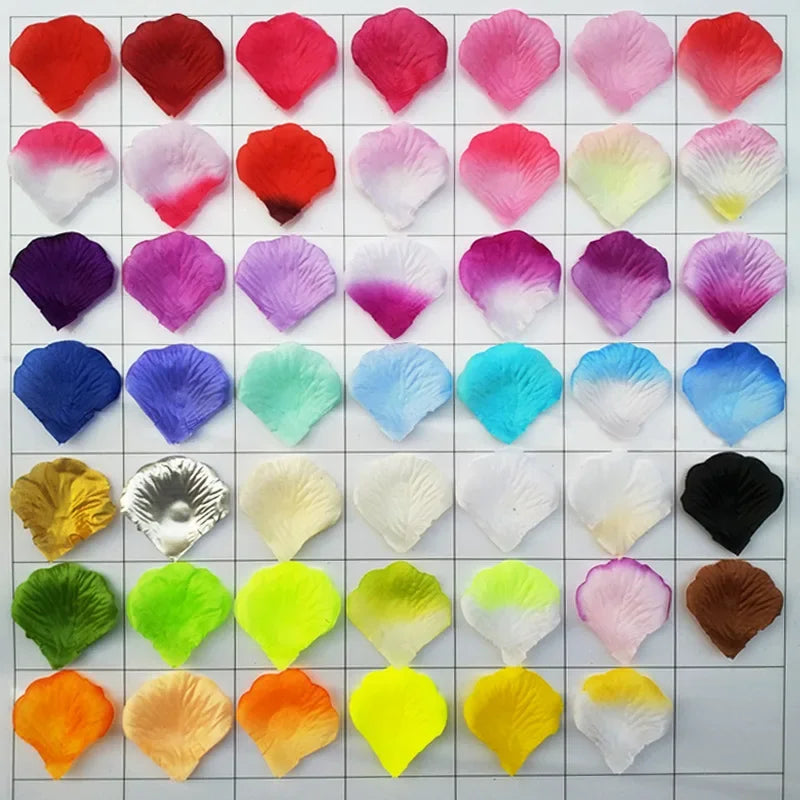 A grid displaying various shades of pink, red, purple, and green silk rose petals for weddings and events.