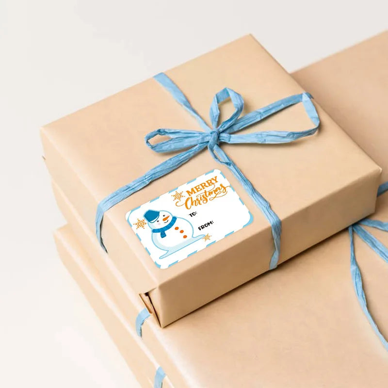 A brown gift box tied with light blue ribbon featuring a square sticker that reads Merry Christmas