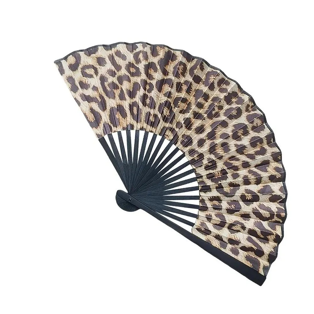A folding hand fan with a leopard print design featuring brown and black spots.