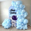 A large balloon arch featuring light blue balloons and a silver astronaut figure for a birthday party decoration.