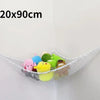 A white mesh storage organizer hammock displaying various colorful stuffed animals.
