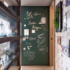 A dark green chalkboard wall sticker featuring hand-drawn text and botanical illustrations.