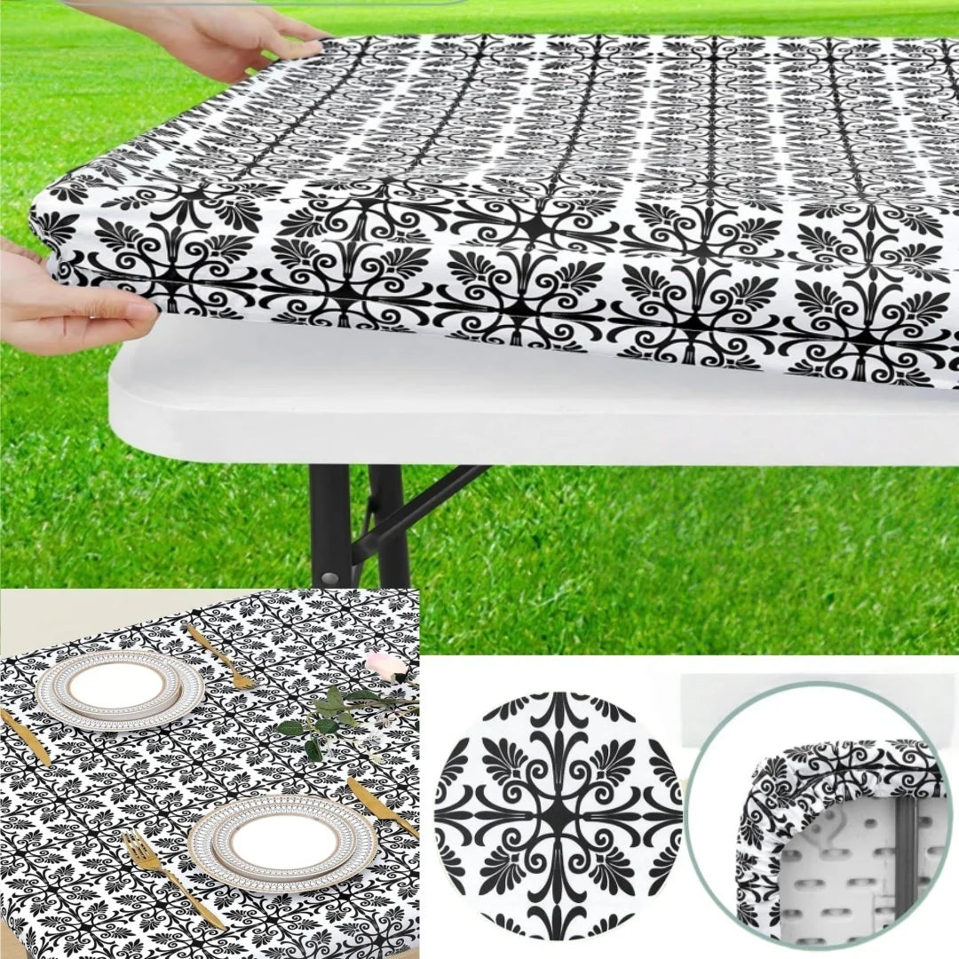 Black and white patterned elastic fitted rectangle tablecloth being held over a white table.