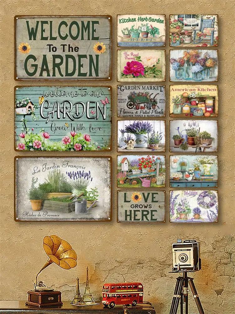 A collection of vintage metal tin signs featuring garden and home decor themes on a textured wall.