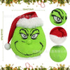 A plush green monster with a red hat and white trim, designed as Christmas wall decor.