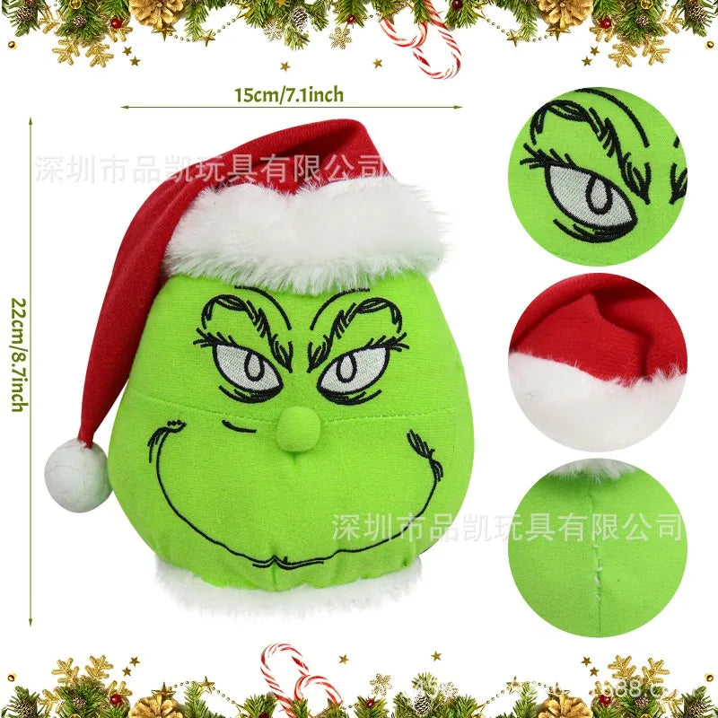 A plush green monster with a red hat and white trim, designed as Christmas wall decor.