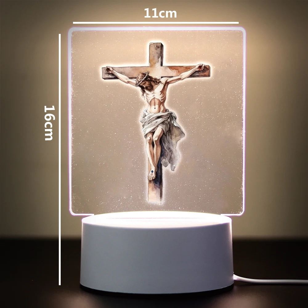 A 3D LED night light depicting a crucifixion scene on a cross, illuminated with a soft glow.