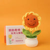 Handmade knitted orange and yellow sunflower flower in a white pot