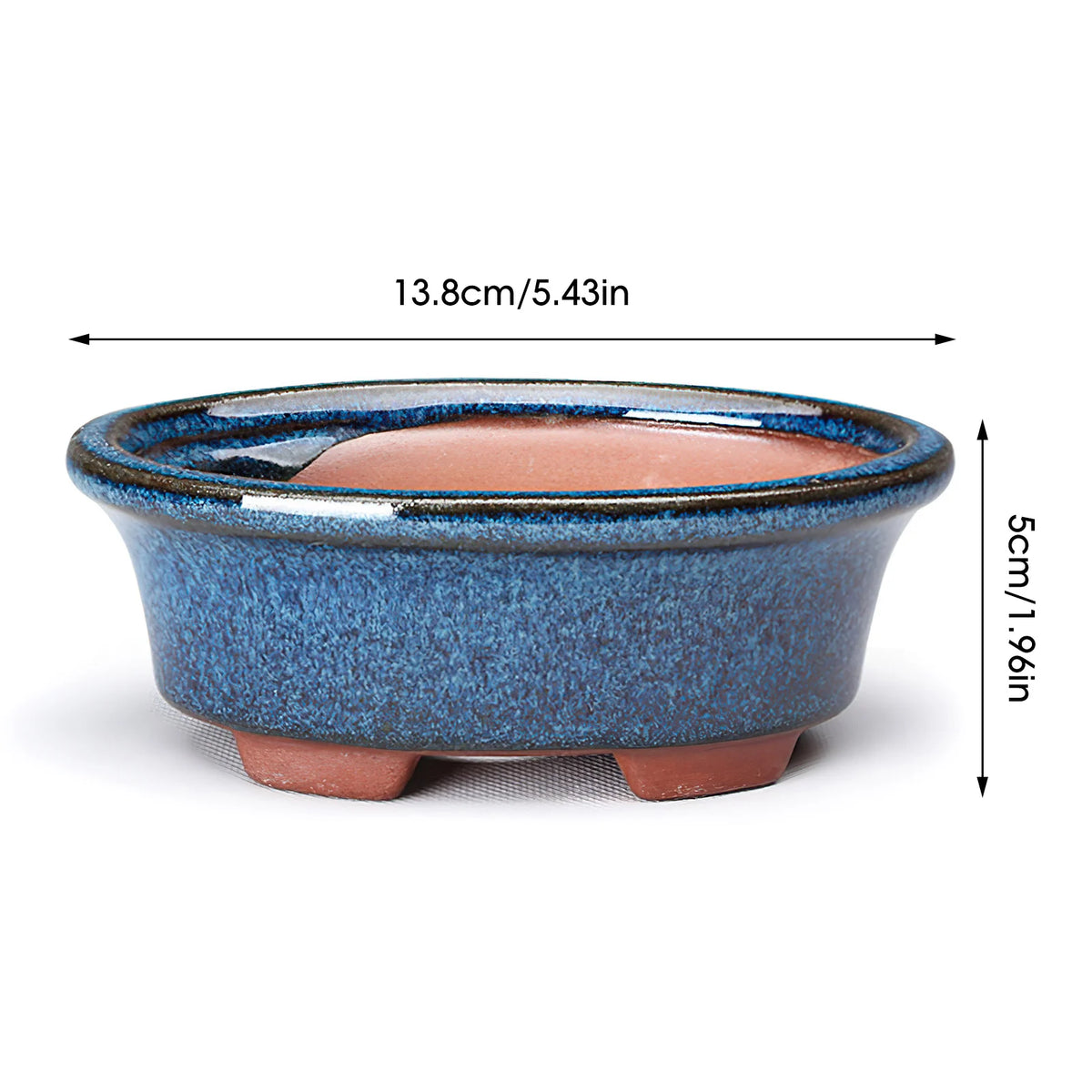 A round ceramic succulent planter in blue and terracotta colors with a drainage hole.