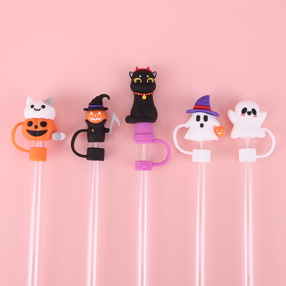 A collection of reusable silicone straw covers shaped like various Halloween characters, including a cat, pumpkin, witch, gho