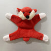 A plush toy of a red fox with white accents, designed as a fridge magnet.