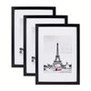 A set of five black wooden picture frames in various sizes displaying a photograph.
