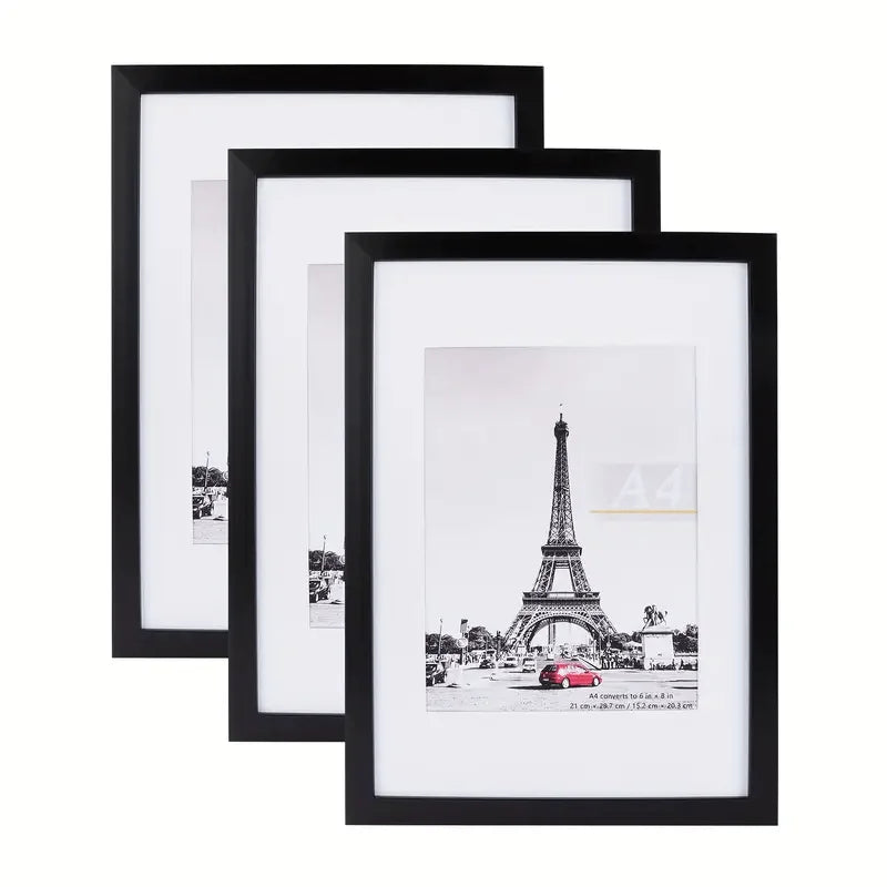A set of five black wooden picture frames in various sizes displaying a photograph.