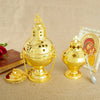 A gold-plated Orthodox censer with bells displayed on a beige cloth next to a religious icon.