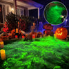 A Halloween laser projector illuminates a yard with green light, featuring skeletons and a carved pumpkin.