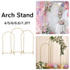 Elegant gold metal arch stand with a floral backdrop for wedding or event decoration.