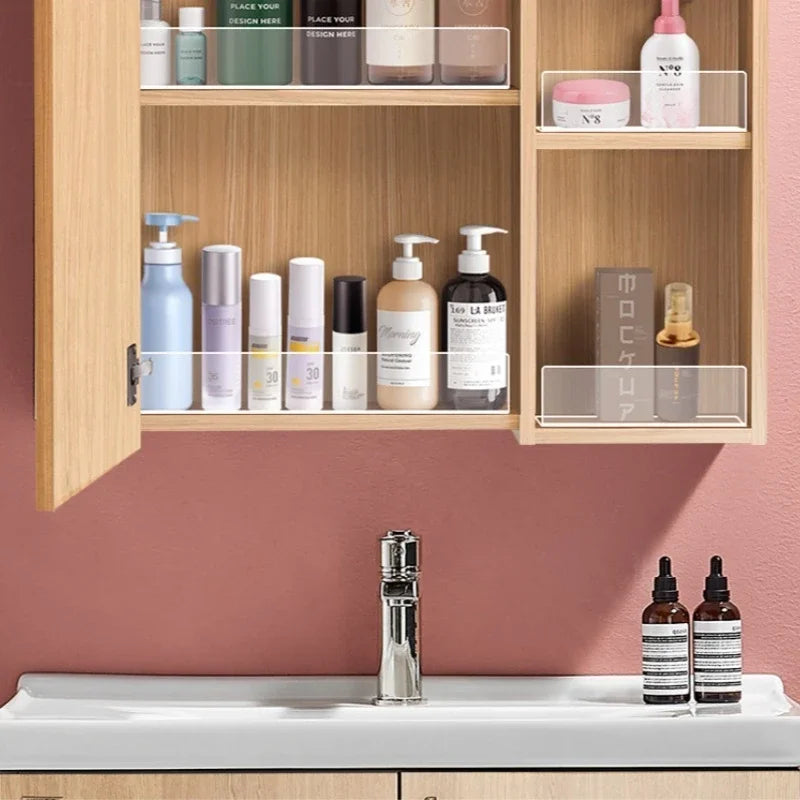 Clear acrylic shelf divider organizing various skincare products in a wooden cabinet