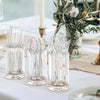 Clear glass containers filled with disposable plastic silverware set on a white tablecloth