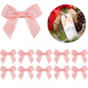 A collection of pink satin ribbon bows with self-adhesive backing shown in various sizes and styles.