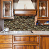 A kitchen cabinet and countertop featuring a textured marble backsplash and wooden cabinetry.