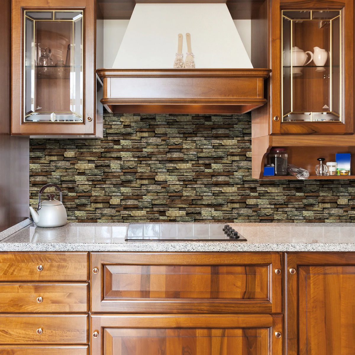 A kitchen cabinet and countertop featuring a textured marble backsplash and wooden cabinetry.