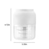 White cordless electric mini food chopper with a clear plastic bowl and grinding blade.