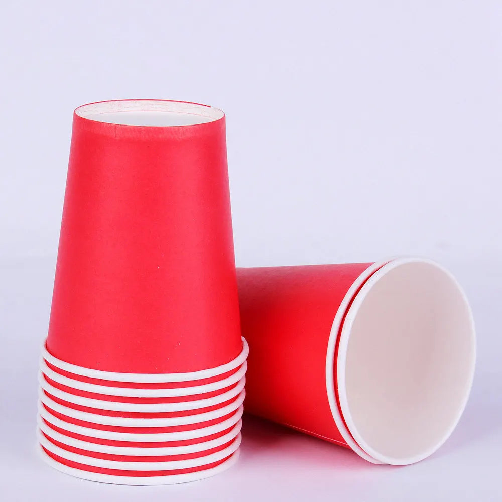 A stack of red and white disposable paper cups for parties and events.