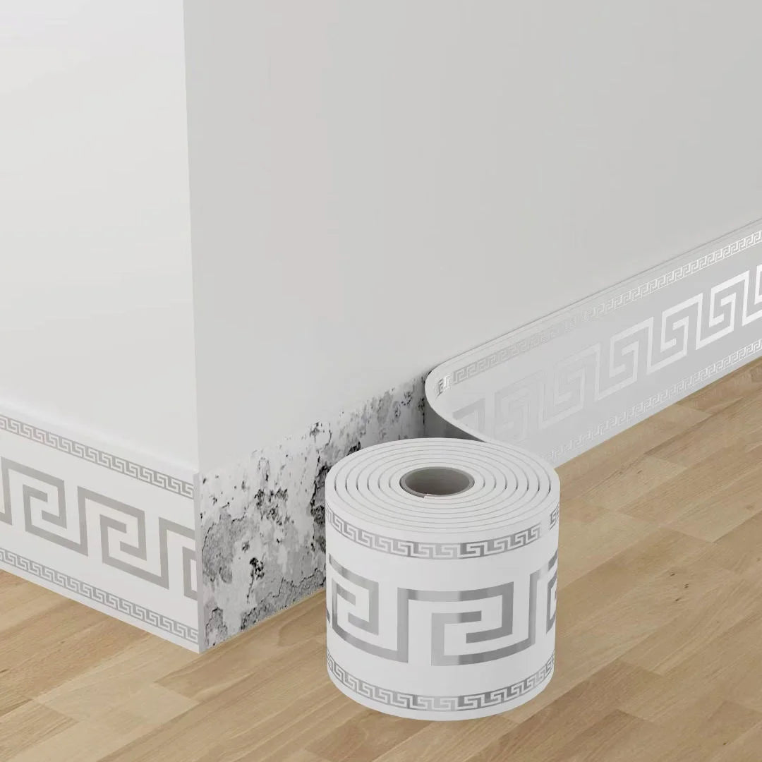 Roll of white self-adhesive PVC baseboard trim featuring a gray brick pattern on a wooden floor.