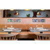 A dining area featuring a wooden bench and tables with vintage metal street sign decor above them.