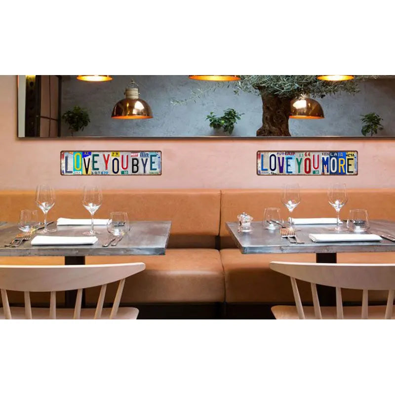 A dining area featuring a wooden bench and tables with vintage metal street sign decor above them.