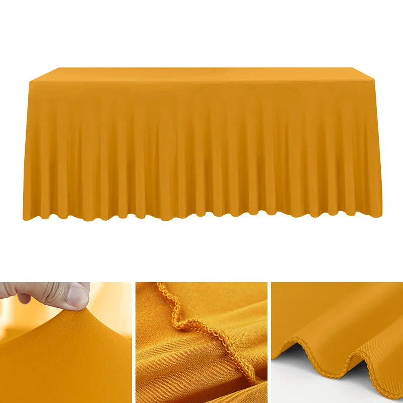 A smooth, mustard yellow stretch rectangle tablecloth draped over a table.