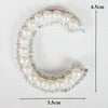 A white pearl letter C alphabet patch embellished with small rhinestones.