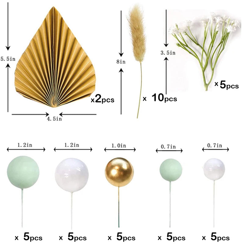 A set of golden palm leaf cake toppers, including pleated leaves and delicate flowers on sticks.