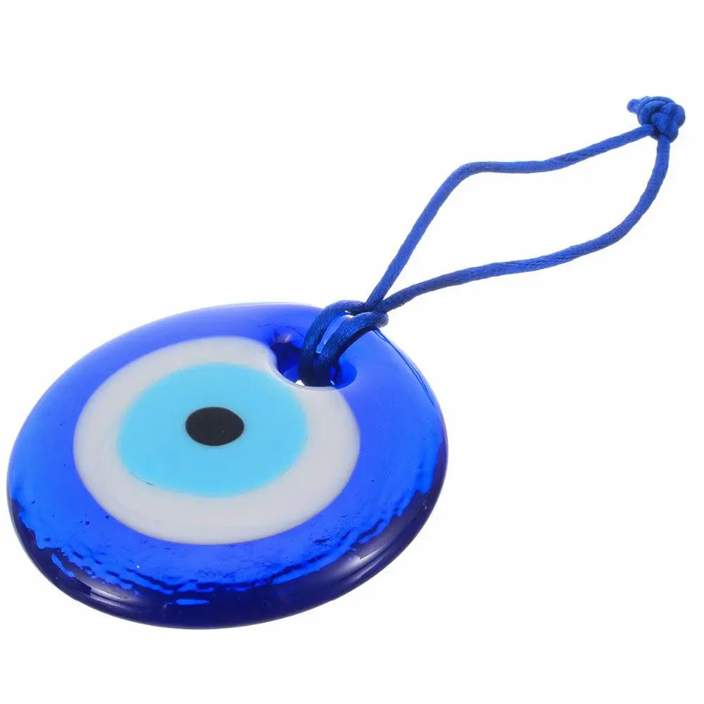 Blue glass evil eye amulet pendant with a thin blue string.