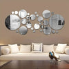 A wall decor set featuring various circular and oval 3D acrylic mirrors in silver and black tones.
