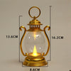 A brass retro battery-powered desk lamp with a clear glass globe and a golden finish.