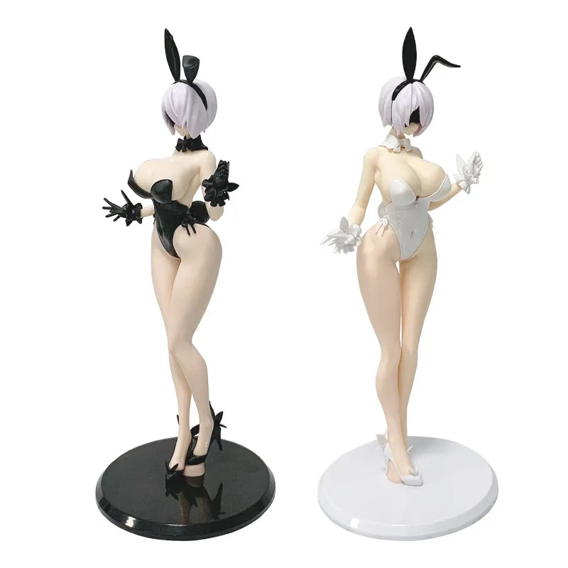 A collectible figure of an anime-style mechanic girl with white hair and black accents, standing on a black base.