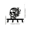 Black iron skull wall hook with floral accent and a wooden plank for display