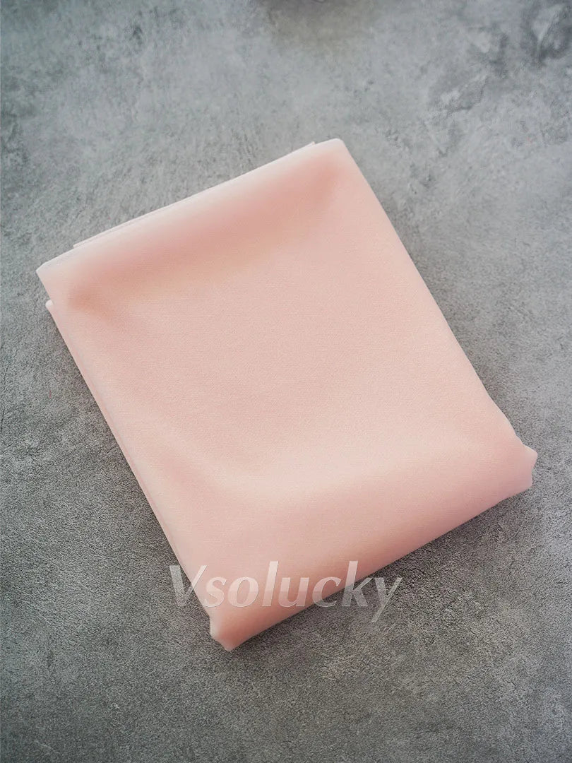 A square piece of light pink chiffon fabric is shown on a gray surface.