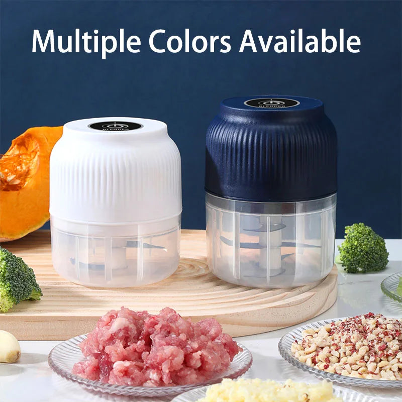 A white electric food chopper is shown next to a blue one, with chopped pink ingredients on a wooden board.