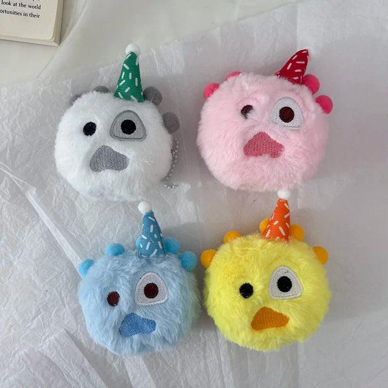 Four pastel-colored plush toys with conical hats, including white, pink, blue, and yellow.