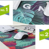 Desk mat featuring a tropical leaf pattern with a white mechanical keyboard and a white computer mouse.