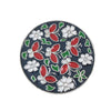 A round decorative piece featuring floral crystal designs in red, green, and white on a dark blue background.