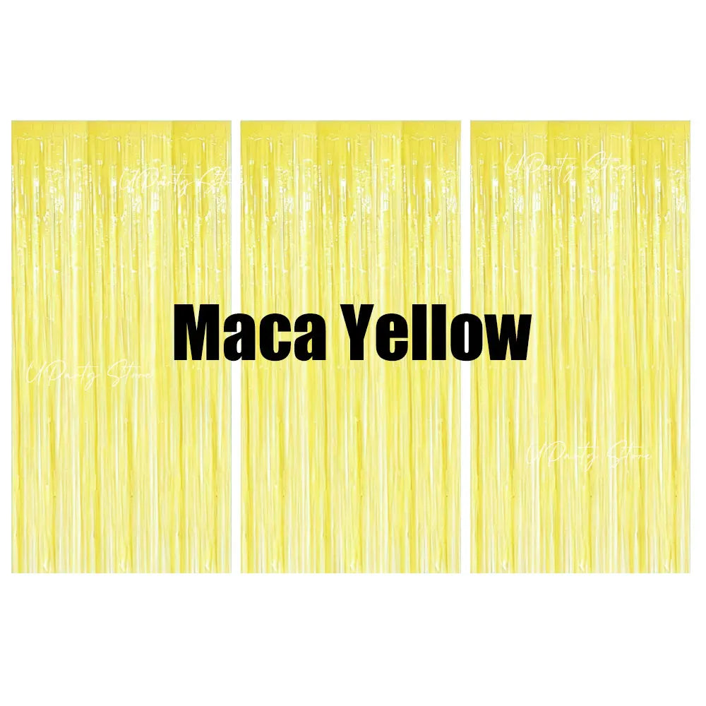 Three vertical panels of yellow metallic foil fringe curtains for party backdrop decor.