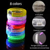 A stack of eight colorful LED flash bracelets, showing various colors and components like switches and batteries.