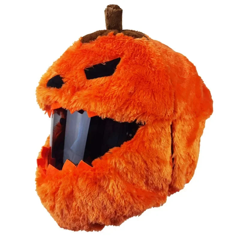 An orange cartoon plush helmet cover designed to resemble a grinning pumpkin face.