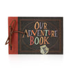 A vintage kraft scrapbook album with a dark brown cover and an orange spine, featuring the text Our Adventure Book.