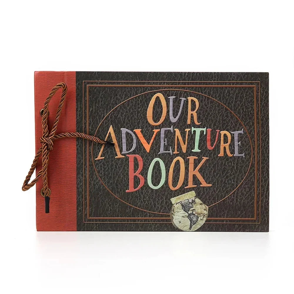 A vintage kraft scrapbook album with a dark brown cover and an orange spine, featuring the text Our Adventure Book.