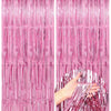 Two panels of metallic pink foil fringe curtains hanging vertically.